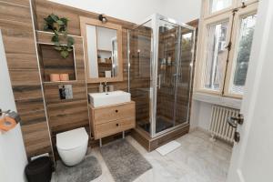 a bathroom with a shower and a toilet and a sink at George&Dragon Rooms in Bucharest +56 photos