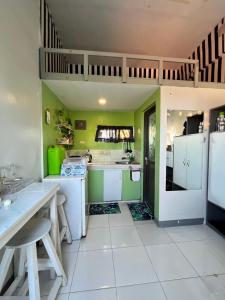 a kitchen with green walls and white appliances at JC Unit #5 