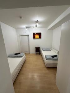 a room with two beds and a wooden floor at Ferienwohnung Kreuzberg in Berlin