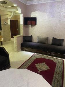 - un salon avec un canapé et une télévision dans l'établissement riad oujda, à Oujda