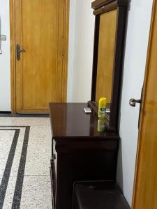 - un bureau en bois avec une bouteille jaune au-dessus dans l'établissement riad oujda, à Oujda