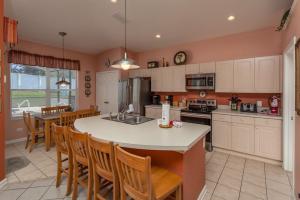 a kitchen with a large island in the middle of a room at 2217 Wyndham Palms in Kissimmee