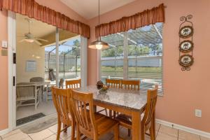 a dining room with a table and chairs at 2217 Wyndham Palms in Kissimmee