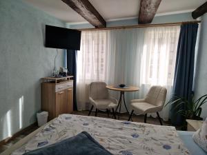 Postel nebo postele na pokoji v ubytování Pension Zum Lukullus