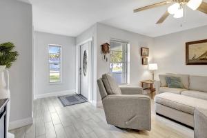 a living room with a couch and a chair at Bungalow Close to Naples Beaches in Naples