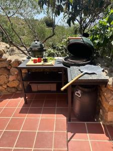 a outdoor grill with two pots and pans on a patio at Landhuis Natural Park - Privacy in Cádiar