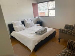 a bedroom with a large bed with white sheets and pillows at Langstrand Self Catering Villa - Sunset & Sunrise Rooftop including BBQ & Fireplace in Langstrand