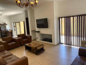 a living room with a couch and a coffee table at Langstrand Self Catering Villa - Sunset & Sunrise Rooftop including BBQ & Fireplace in Langstrand