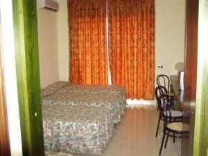 Postel nebo postele na pokoji v ubytování Hotel Le Dune