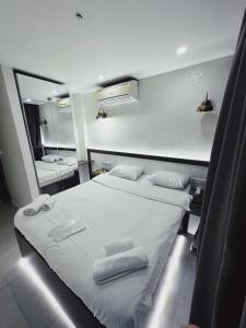 a bedroom with a white bed with towels on it at Kadıköy Duck hotel in Istanbul