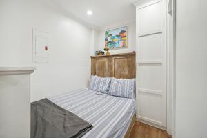 a small bedroom with a bed in the corner at Downtown Wilmington Studio in Historic District! in Wilmington