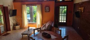 a living room with a table and a couch at La Bellota in Villa Ventana