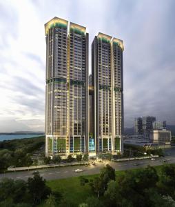 two tall buildings in front of a city at JZstay - Atlantis Residences Melaka - 1BR & 2BR in Melaka