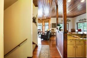 a kitchen and living room with a wooden ceiling at Beautiful Mountain Views and Privacy. Minutes to downtown Gatlinburg and National Park in Gatlinburg