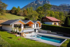 a house with a swimming pool in a yard at Villa Trois Lauriers - OVO Network in Écharvine