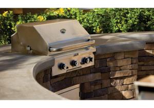 a grill on a stone wall in a yard at Escape to Tropicana, a Tranquil Condo Oasis Near the LV Strip - Special Offer Now! in Las Vegas