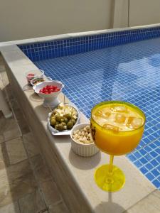 a buffet of food next to a swimming pool at Pousada Casarão in Cruzília