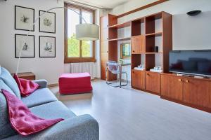 a living room with a couch and a television at Arc of Peace - Exclusive Apartment in Milan