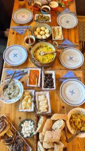 a wooden table with plates of food on it at Siya dome & glamping in Çamlıhemşin