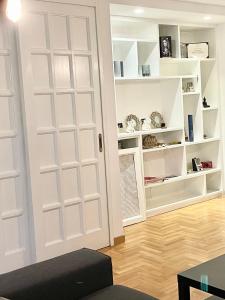 a room with white doors and white shelves at Appartamento nel verde fronte ospedale San Pietro, Sant'Andrea in Rome