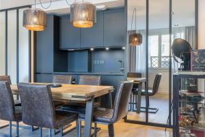 a dining room with a wooden table and chairs at Atelier in Paris