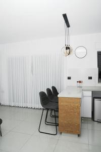 a kitchen with four chairs and a table and a counter at The best location in Jerusalem 1 in Jerusalem
