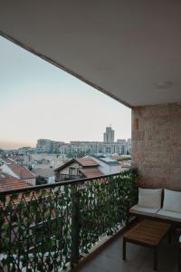 a balcony with a bench and a view of a city at The best location in Jerusalem 1 in Jerusalem