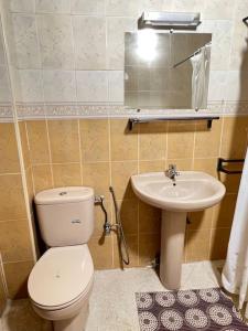 a small bathroom with a toilet and a sink at Maison à harhoura prêts de la plage in Rabat