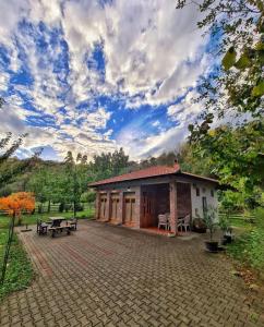 a building with a pavilion in a park at Apartman Quince Gradac in Valjevo