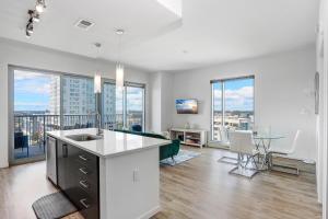 a kitchen and living room with views of a city at Stunning 2-Bed Condo with Panoramic DT Tampa Views in Tampa