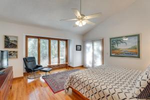 a bedroom with a bed and a ceiling fan at Spacious Kiawah Island Home with Deck, Walk to Beach in Johns Island