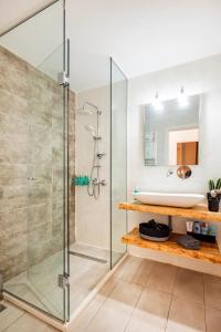 a bathroom with a glass shower and a sink at Santa Triada in Heraklio