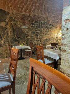 a dining room with tables and chairs and a brick wall at Hotel Logge Dei Mercanti in Monte San Savino