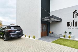 a car parked in front of a building at Na Fursie Apartments & Rooms in Nowy Targ