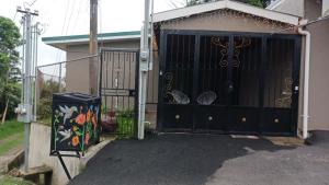 a garage with a black door with a gate at Monteverde Guesthouse in Monteverde Costa Rica