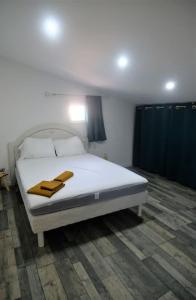 a bedroom with a bed with two towels on it at Maison au cœur du Minervois in Pouzols-Minervois