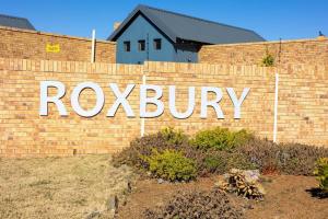a brick wall with a roxbury sign on it at Grace @ Rayton in Bloemfontein