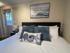 a bedroom with a bed with white sheets and pillows at Bright & Spacious 1 BR- King Bed & Private Yard in Providence