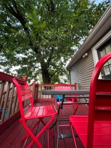 a group of red chairs and a table on a deck at Bright & Spacious 1 BR- King Bed & Private Yard in Providence