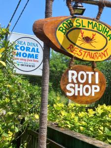 a sign for a restaurant with a hot dog and a not shop at Seadina Coral Home in Matara
