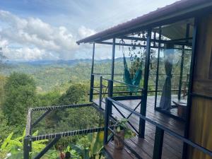 a house with a balcony with a view of the mountains at Glamping El Pinar in San Francisco
