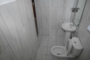 a small bathroom with a toilet and a sink at Shali Hotel in Wote