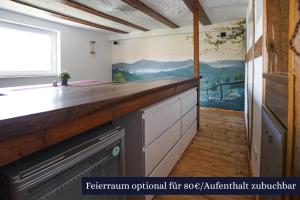 a kitchen with a counter with a painting on the wall at Rhöner Heim in Kaltennordheim