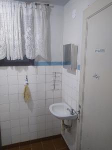 a bathroom with a sink and a window at Apartamento Pé na Areia com Vista Mar e Wi-fi LOFTJL com 01 vaga de garagem sujeita a disponibilidade in Santos