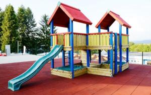 a playground with a slide in a park at Penzion MIMA V Kováčovej in Kováčová