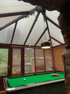 a pool table in a room with a ceiling at Ivy Cottage, Aberfeldy - Highland Perthshire in Aberfeldy