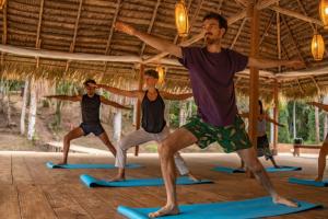 a group of men in a yoga class at Aparthotel Ayahuaska for SOLO travelers in Iquitos