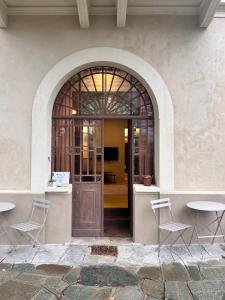 an entrance to a building with a wooden door and chairs at Villa Sardino in Settimo Vittone
