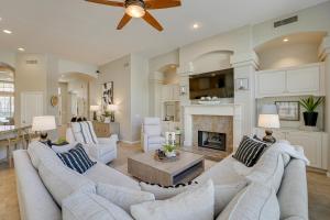 a living room with white furniture and a fireplace at Luxe Scottsdale Retreat Pool, Hot Tub and More! in Phoenix