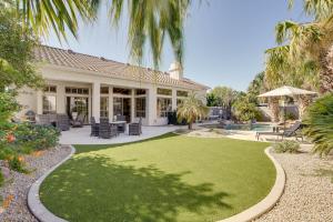 a house with a large yard with green grass at Luxe Scottsdale Retreat Pool, Hot Tub and More! in Phoenix